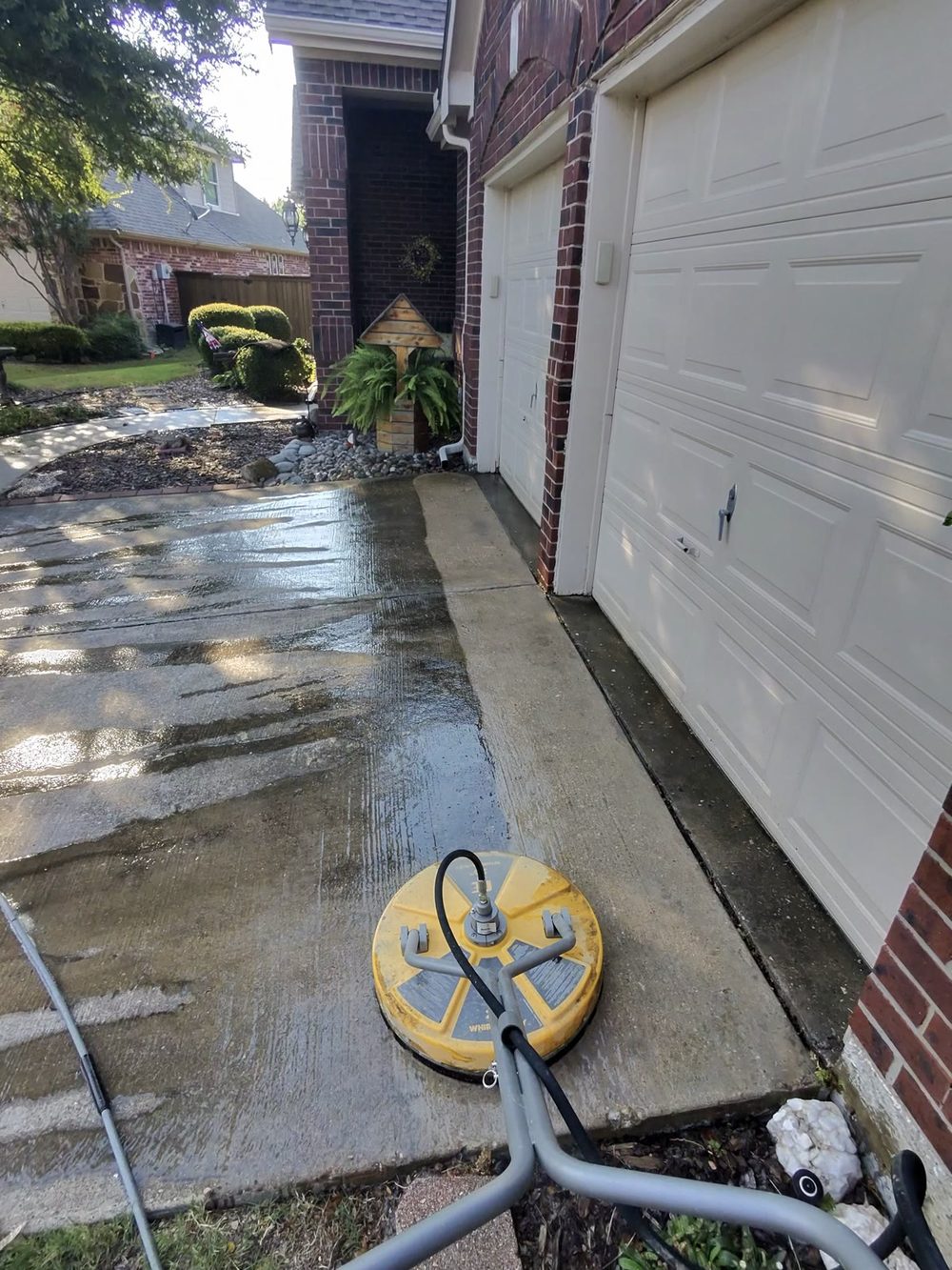 Hot-water pressure washing a concrete driveway in McKinney, Texas — Green Clean Machine