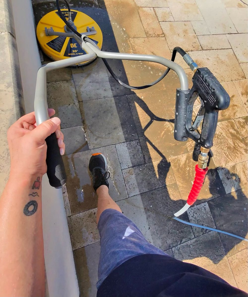 Paver patio detail cleaning with a pressure washer wand in Plano, Texas — Green Clean Machine