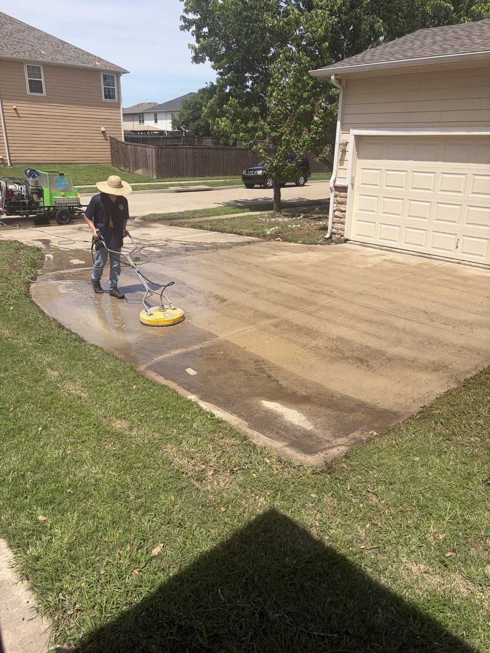 Morgan Helshoj cleaning a concrete driveway with hot water in Collin County, Texas